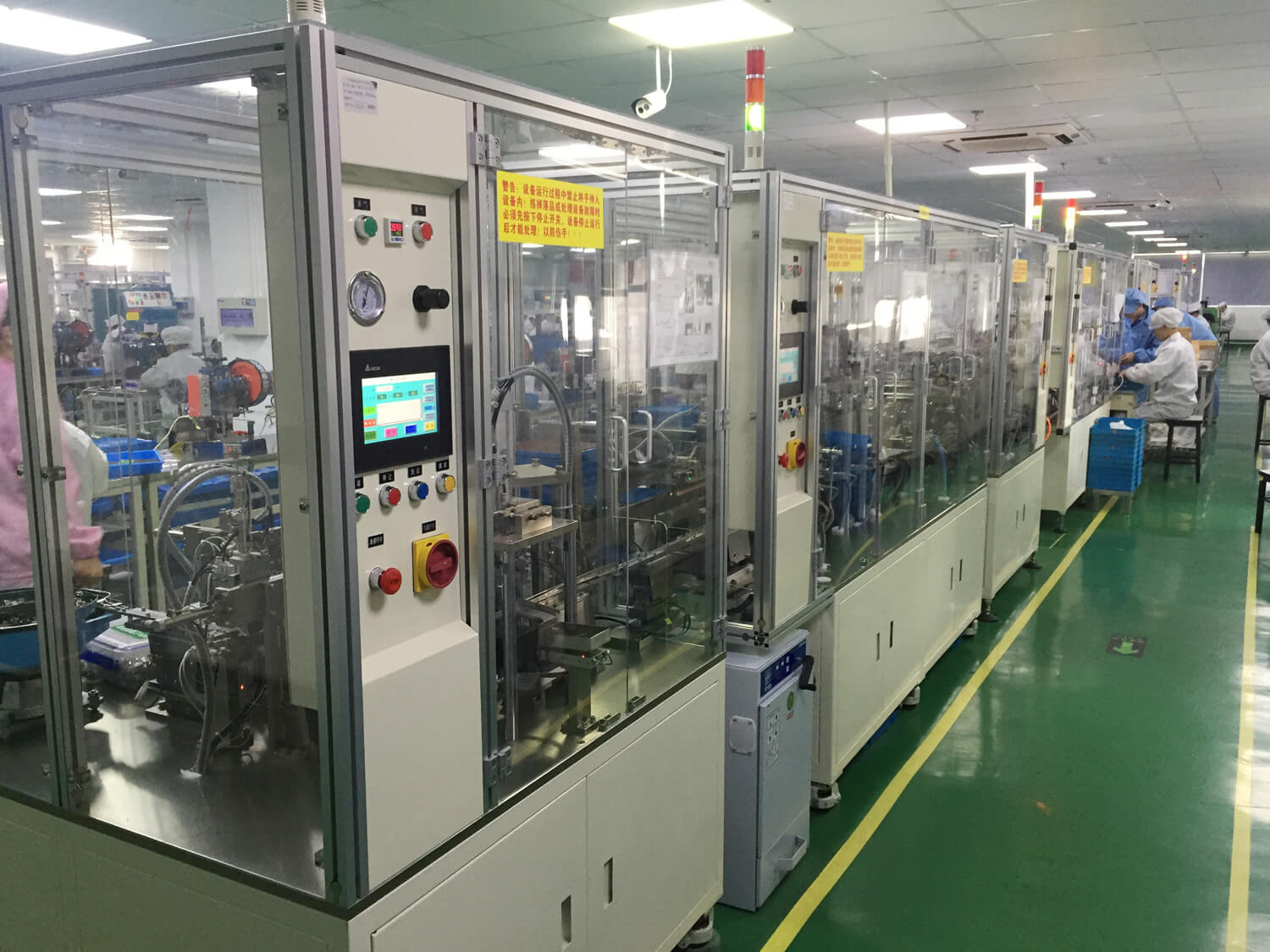 Youge production line with operator control panel and enclosed work sections